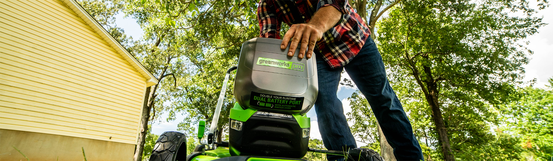 Man changing the battery in his push mower